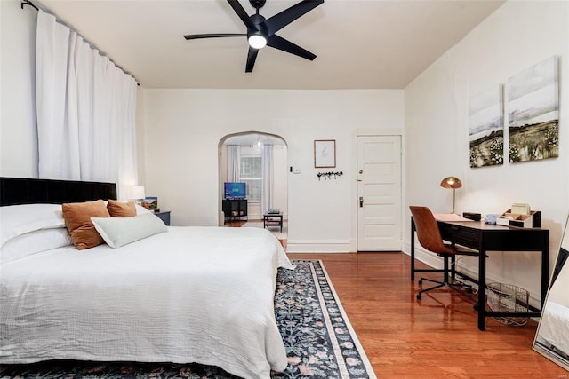 4271 Botanical Ave, Saint Louis, MO 63110 - bedroom with wood finished floors, arched walkways, an office area, and a ceiling fan