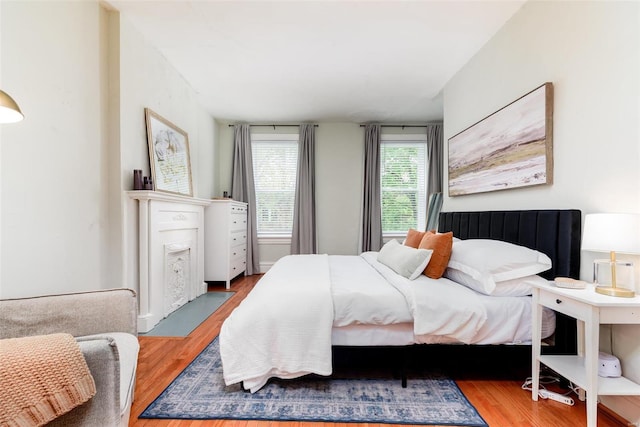 4271 Botanical Ave, Saint Louis, MO 63110 - bedroom with wood finished floors and a fireplace with flush hearth
