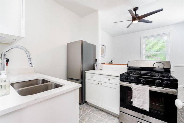 4271 Botanical Ave, Saint Louis, MO 63110 - kitchen with stainless steel appliances, a sink, white cabinetry, a ceiling fan, and light stone countertops