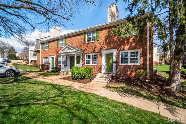 1528 Thrush Ter, Brentwood, MO 63144 - view of front facade with a chimney, brick siding, and a front lawn