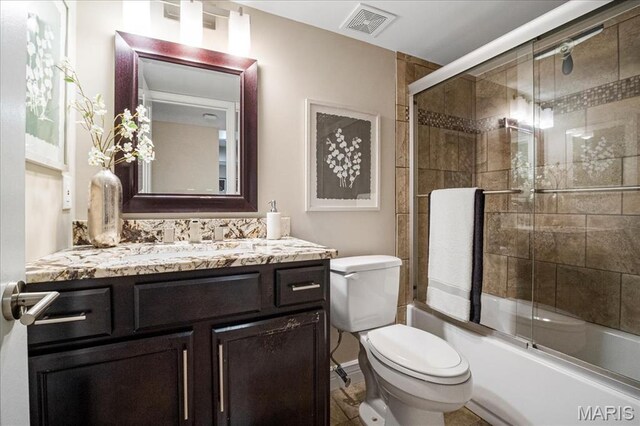 1528 Thrush Ter, Brentwood, MO 63144 - bathroom with vanity, toilet, and bath / shower combo with glass door