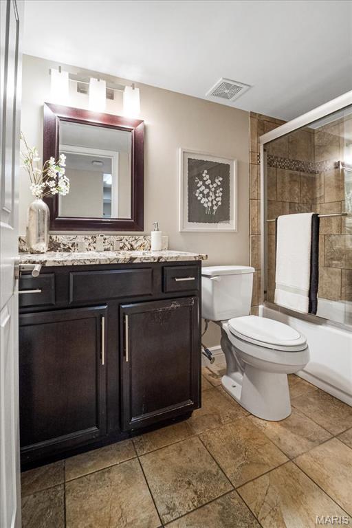 1528 Thrush Ter, Brentwood, MO 63144 - full bath featuring toilet, vanity, and shower / bath combination with glass door