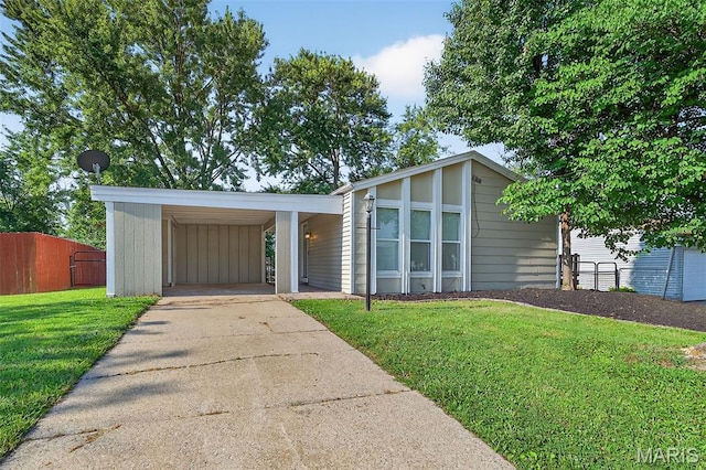 104 Wild Winds Dr, Ofallon, MO 63368 - mid-century modern home with concrete driveway and a carport