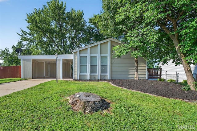 104 Wild Winds Dr, Ofallon, MO 63368 - mid-century home with concrete driveway and an attached carport