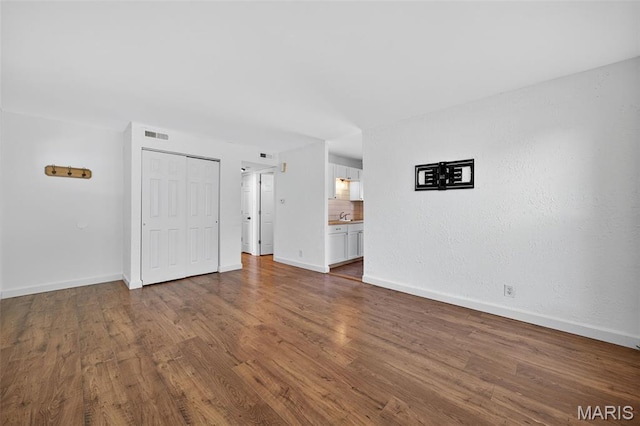 104 Wild Winds Dr, Ofallon, MO 63368 - unfurnished living room featuring wood finished floors