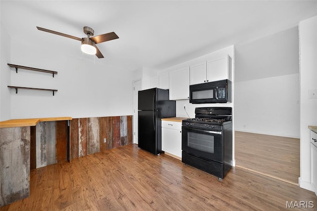 104 Wild Winds Dr, Ofallon, MO 63368 - kitchen featuring black appliances, white cabinets, a ceiling fan, wood finished floors, and light countertops