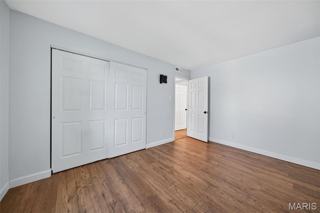 104 Wild Winds Dr, Ofallon, MO 63368 - unfurnished bedroom with wood finished floors and a closet