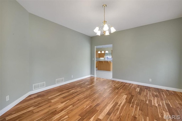 1736 Debra Ln, Arnold, MO 63010 - spare room with a chandelier, light wood-style flooring, and baseboards
