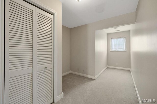 1736 Debra Ln, Arnold, MO 63010 - unfurnished bedroom featuring a closet, baseboards, and light carpet