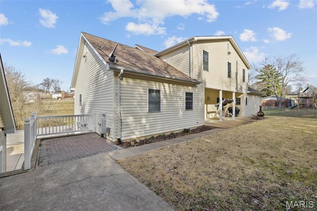 1736 Debra Ln, Arnold, MO 63010 - back of property featuring a patio, a yard, and a shingled roof