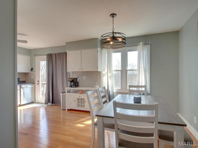 14160 Turkey Run Ct, New London, MO 63459 - dining area with light wood finished floors and a chandelier