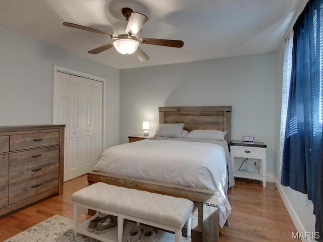 14160 Turkey Run Ct, New London, MO 63459 - bedroom with light wood-style flooring, a closet, and ceiling fan