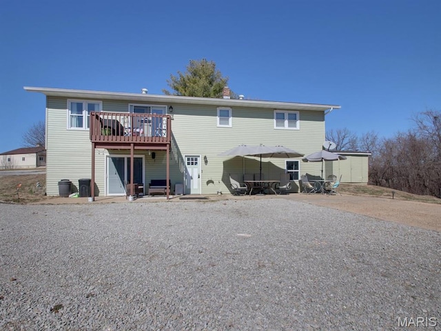14160 Turkey Run Ct, New London, MO 63459 - rear view of house featuring a wooden deck, outdoor dining space, and a patio