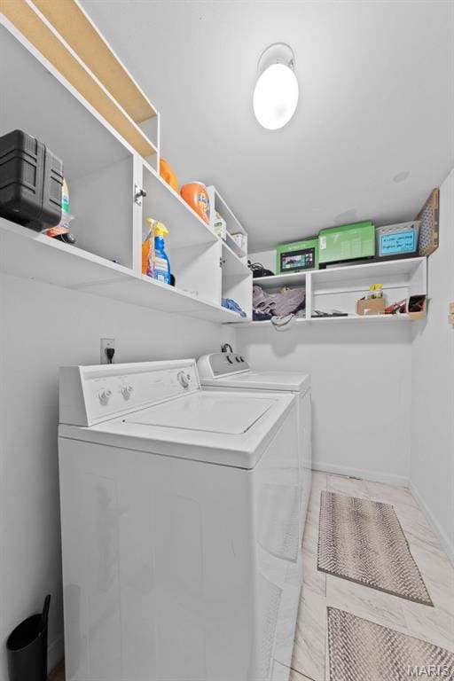laundry area featuring separate washer and dryer and baseboards
