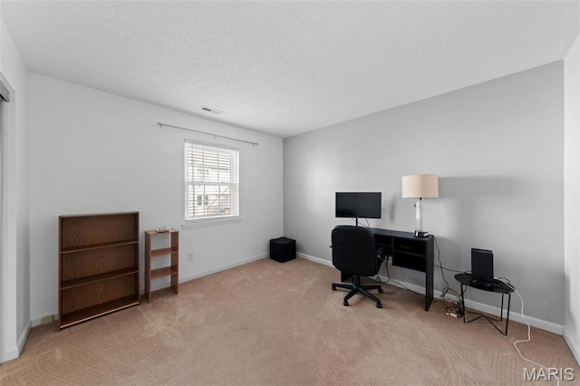 office area featuring carpet, a textured ceiling, and baseboards