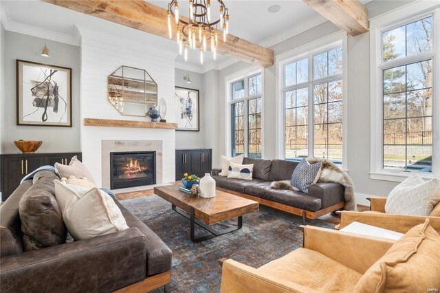 310 Wardenburg Farms Dr, Chesterfield, MO 63005 - living room featuring beamed ceiling, a chandelier, wood finished floors, plenty of natural light, and a fireplace