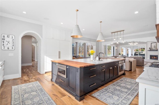 310 Wardenburg Farms Dr, Chesterfield, MO 63005 - kitchen with appliances with stainless steel finishes, a large island with sink, white cabinetry, open floor plan, and recessed lighting