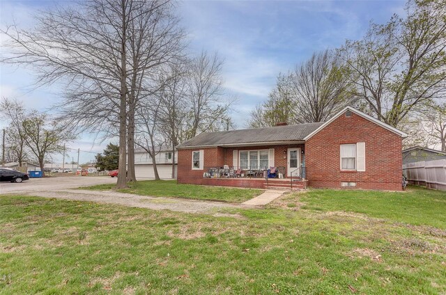 1125 N Market St, Sparta, IL 62286 - ranch-style home with brick siding, covered porch, and a chimney