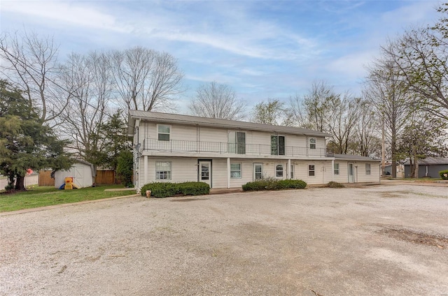 1125 N Market St, Sparta, IL 62286 - view of property featuring a storage shed, an outdoor structure, a balcony, and fence