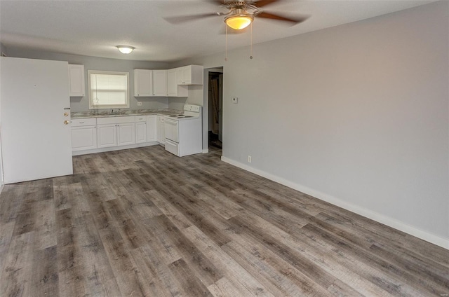 1125 N Market St, Sparta, IL 62286 - kitchen featuring white electric range, a ceiling fan, a sink, light countertops, and wood finished floors