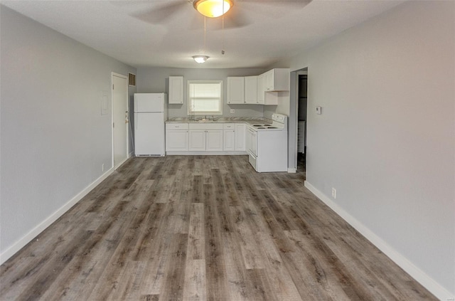 1125 N Market St, Sparta, IL 62286 - kitchen with white appliances, ceiling fan, wood finished floors, light countertops, and white cabinets