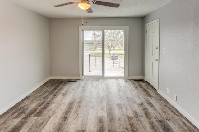 1125 N Market St, Sparta, IL 62286 - spare room with a ceiling fan, wood finished floors, baseboards, and a textured ceiling