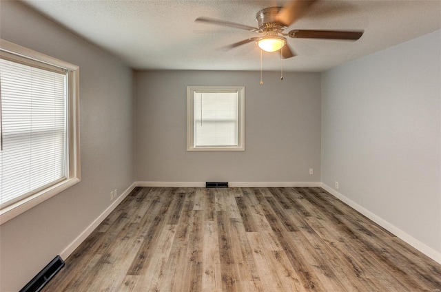 1125 N Market St, Sparta, IL 62286 - spare room featuring wood finished floors, a ceiling fan, baseboards, and a textured ceiling