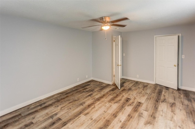 1125 N Market St, Sparta, IL 62286 - empty room featuring a ceiling fan, wood finished floors, and baseboards
