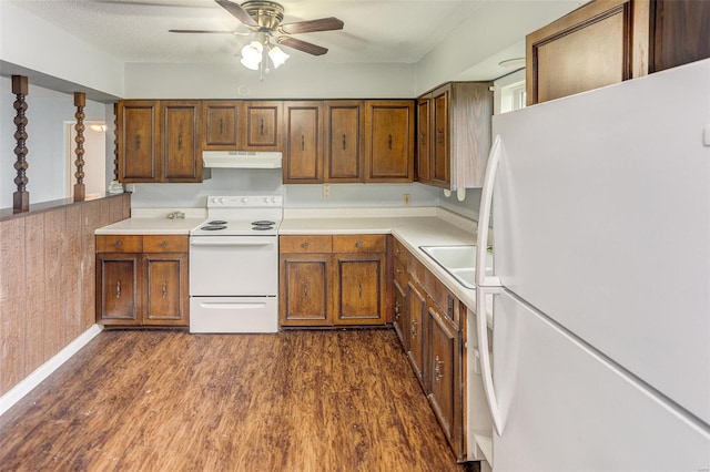 1125 N Market St, Sparta, IL 62286 - kitchen featuring white appliances, under cabinet range hood, ceiling fan, light countertops, and dark wood-type flooring