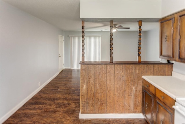 1125 N Market St, Sparta, IL 62286 - kitchen featuring a ceiling fan, brown cabinetry, dark wood-style floors, and baseboards