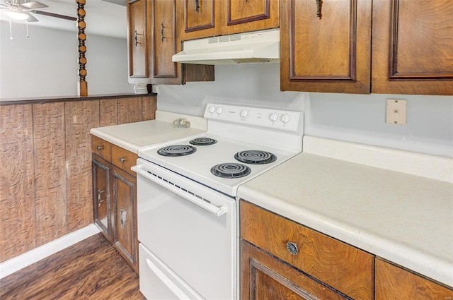 1125 N Market St, Sparta, IL 62286 - kitchen featuring white range with electric stovetop, under cabinet range hood, dark wood-type flooring, brown cabinets, and a ceiling fan