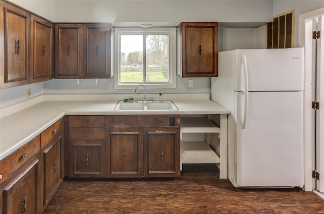 1125 N Market St, Sparta, IL 62286 - kitchen featuring freestanding refrigerator, a sink, light countertops, and dark wood-style flooring