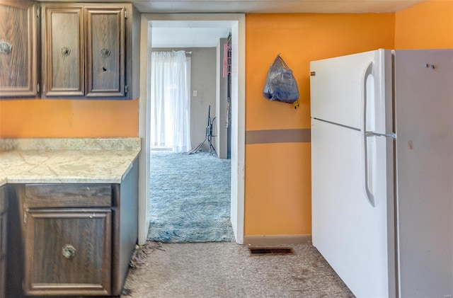 1125 N Market St, Sparta, IL 62286 - kitchen featuring freestanding refrigerator, carpet floors, and light countertops