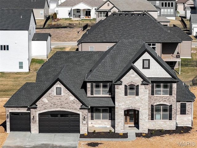 1 Canebrake Ct, Wentzville, MO 63385 - french provincial home featuring a shingled roof, concrete driveway, and stone siding