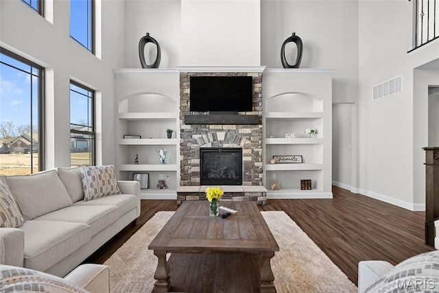 1 Canebrake Ct, Wentzville, MO 63385 - living room with a high ceiling, built in features, baseboards, a stone fireplace, and wood finished floors