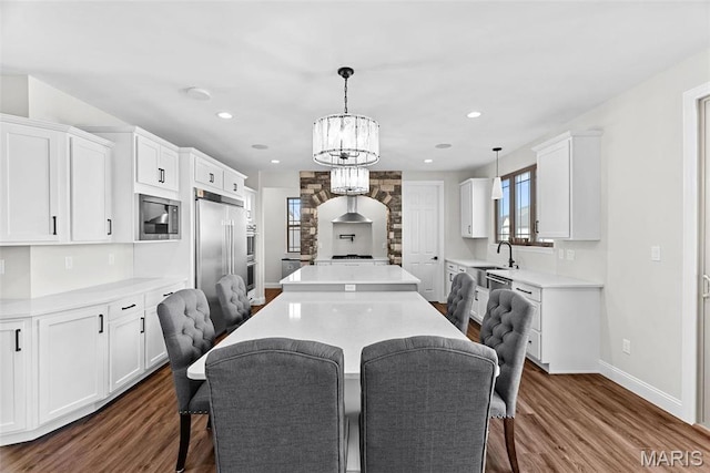 1 Canebrake Ct, Wentzville, MO 63385 - dining area featuring dark wood-type flooring, baseboards, a chandelier, and recessed lighting