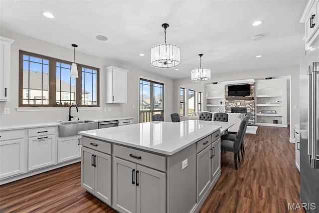 1 Canebrake Ct, Wentzville, MO 63385 - kitchen featuring a sink, open floor plan, a chandelier, a kitchen island, and dark wood-type flooring