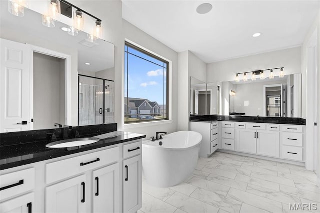 1 Canebrake Ct, Wentzville, MO 63385 - full bath with marble look tiles, a shower stall, two vanities, a freestanding tub, and recessed lighting
