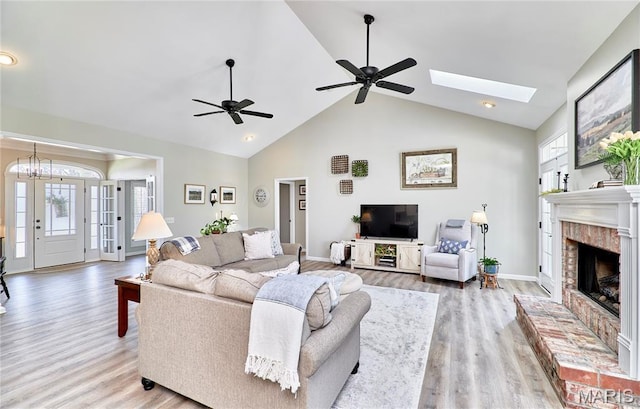 269 Bennington Dr, Troy, MO 63379 - living area featuring plenty of natural light, wood finished floors, a brick fireplace, high vaulted ceiling, and a ceiling fan