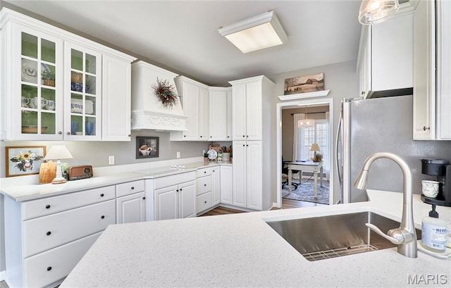 269 Bennington Dr, Troy, MO 63379 - kitchen featuring white cabinets, glass insert cabinets, stovetop, and freestanding refrigerator