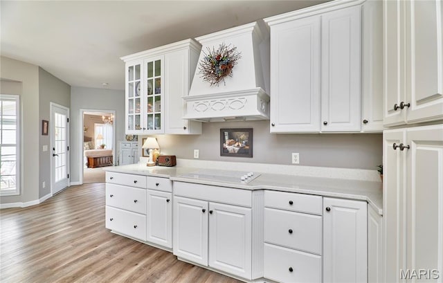 269 Bennington Dr, Troy, MO 63379 - kitchen with electric cooktop, custom range hood, light wood-style floors, and white cabinetry