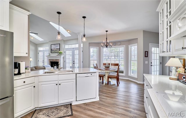 269 Bennington Dr, Troy, MO 63379 - kitchen with dishwasher, freestanding refrigerator, a ceiling fan, light countertops, and light wood-style floors