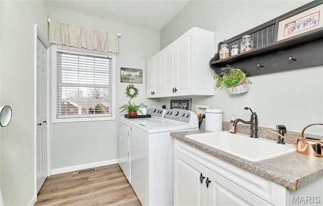 269 Bennington Dr, Troy, MO 63379 - washroom with separate washer and dryer, light wood finished floors, and cabinet space