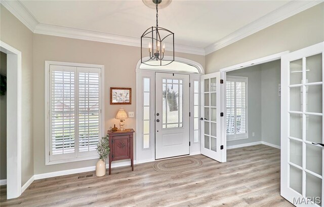 269 Bennington Dr, Troy, MO 63379 - foyer with french doors, crown molding, wood finished floors, and a chandelier