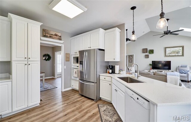 269 Bennington Dr, Troy, MO 63379 - kitchen featuring white appliances, a ceiling fan, open floor plan, light wood-type flooring, and a peninsula
