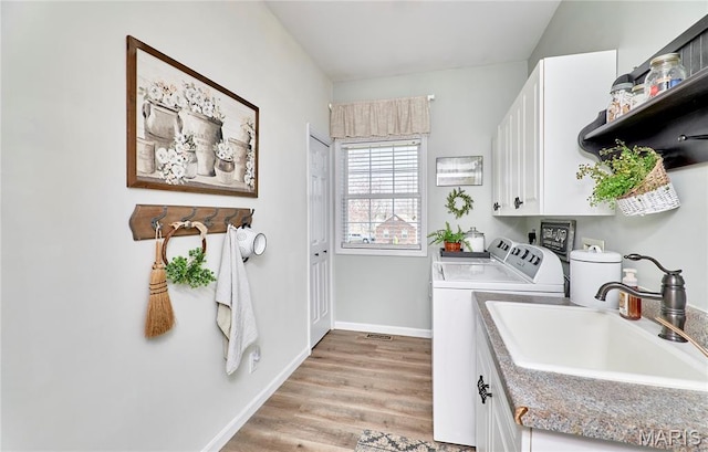 269 Bennington Dr, Troy, MO 63379 - washroom featuring cabinet space, washer and dryer, and light wood-type flooring
