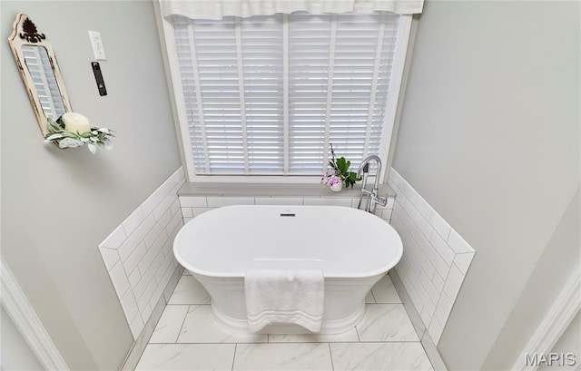269 Bennington Dr, Troy, MO 63379 - full bathroom featuring a freestanding tub, marble finish floors, wainscoting, and tile walls