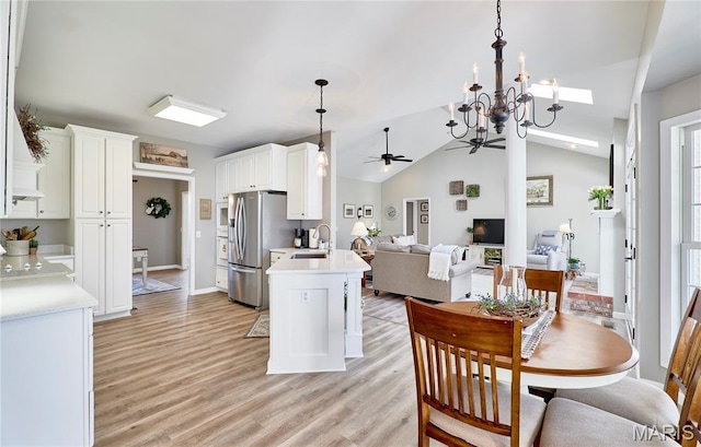 269 Bennington Dr, Troy, MO 63379 - dining room with a ceiling fan, a chandelier, light wood-style flooring, and vaulted ceiling
