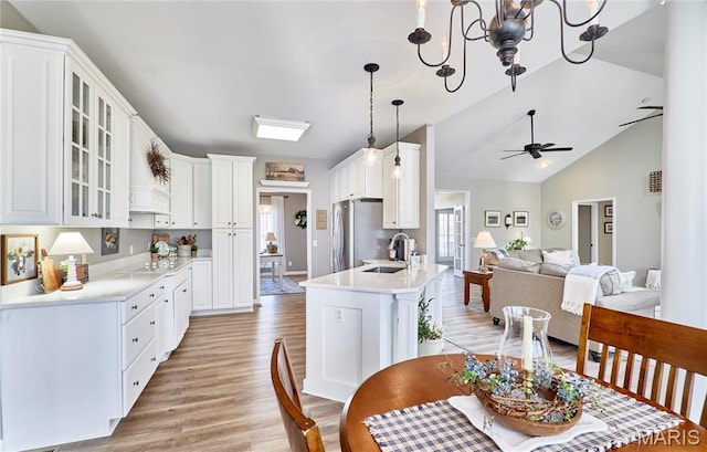 269 Bennington Dr, Troy, MO 63379 - kitchen featuring freestanding refrigerator, light wood-type flooring, open floor plan, glass insert cabinets, and white cabinets