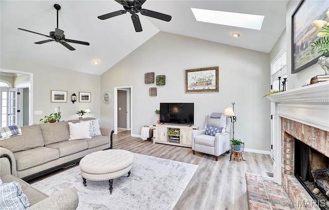 269 Bennington Dr, Troy, MO 63379 - living room featuring a fireplace, wood finished floors, a ceiling fan, plenty of natural light, and high vaulted ceiling